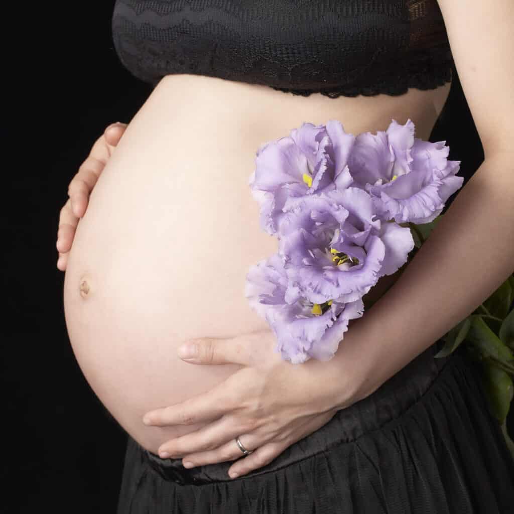 妊婦のお腹とトルコキキョウの花を組み合わせたマタニティフォト撮影