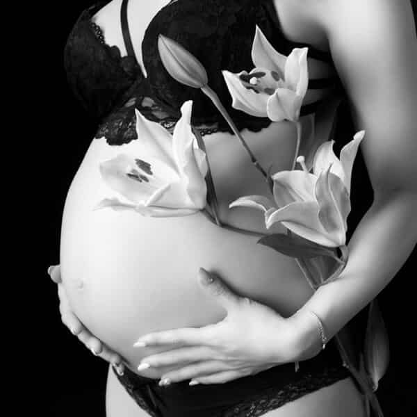 Client testimonial -- maternity photo captured with a cool look in a black dress