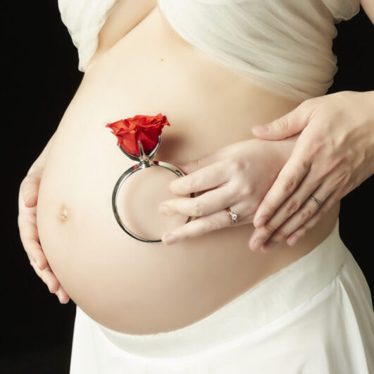 妊婦のお腹と薔薇の花を組み合わせたマタニティフォト撮影